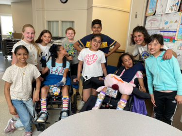 Group of diverse learners gathered together for a photo with smiling faces