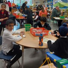 3 young male students working at a classroom table