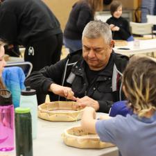 Drum Maker, Darren Charlie, supporting students with drum making